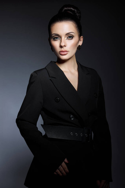 Classic beauty portrait of woman with perfect evening makeup on dark background. Perfect skin without wrinkles, professional beauty makeup, long eyelashes. Perfect girl in black clothes - Фото, изображение