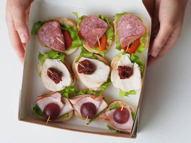 set sandwiches in cardboard packaging in portions in catering services delivery - Photo, Image