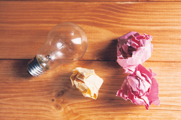 light bulb and crumpled papers - 写真・画像