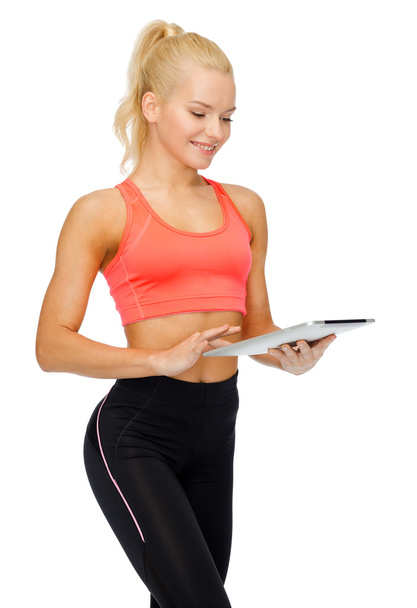 smiling sporty woman with tablet pc computer - Foto, imagen