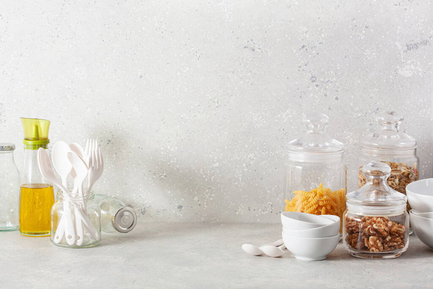 kitchen utensils on modern simple counter, kitchenware jars with dry ingredients bowls - Foto, Imagem