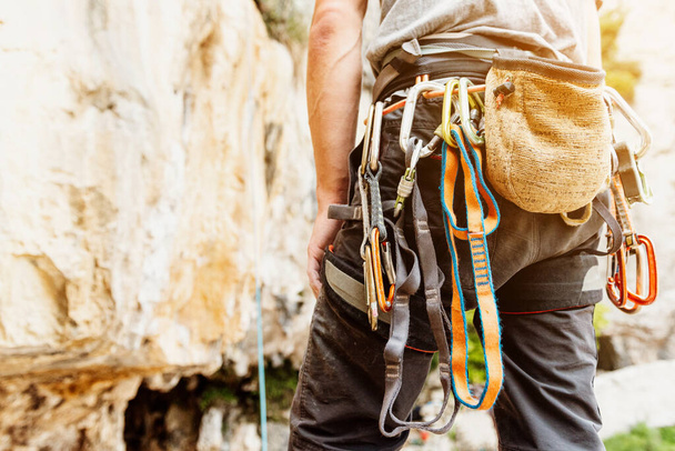 unrecognizable person with safety harness, climbing hooks and magnesium sack. climbing equipment. Mountain Sports. - Fotó, kép