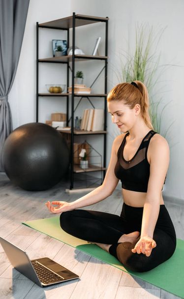 home yoga wellness online relaxed woman laptop - Foto, imagen