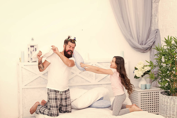 dad and daughter child playing and fighting with pillows having fun together, happy family day - 写真・画像