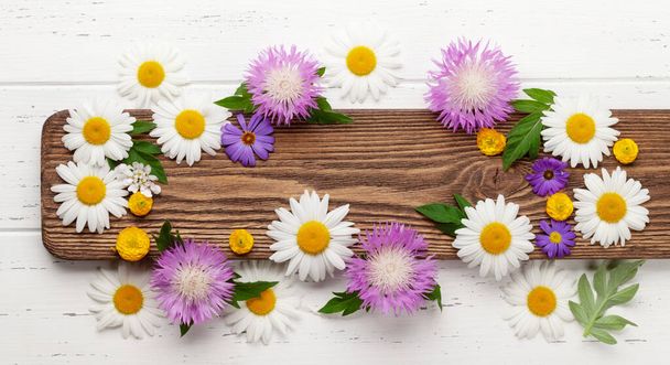Various colorful garden flowers over wooden background. Greeting card template. Top view flat lay with copy space - Fotoğraf, Görsel