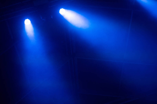 Blue stage lights glowing in the dark. Live music festival concept background - Foto, Imagem