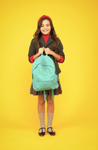 Schooling in style. Happy child hold school backpack yellow background. Book bag of knowledge. September 1. Knowledge day. Back to school. Primary education. Private teaching. Startup - Foto, Imagem