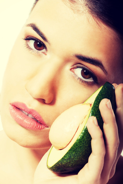 Beautiful woman holding avocado - 写真・画像