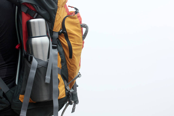 Steel thermos in the pocket of the backpack. Tourist Traveler bag. Adventure Walk. - Foto, Imagen