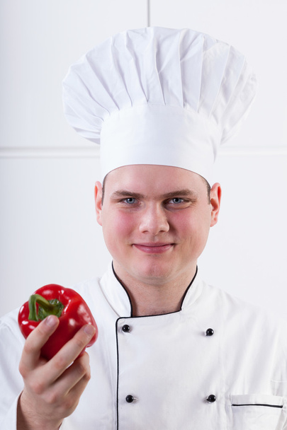 Young chef with pepper - Foto, afbeelding