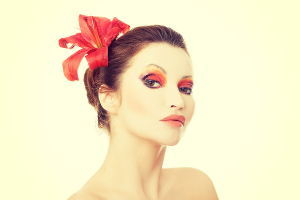Beautiful woman with a red lily - Fotoğraf, Görsel