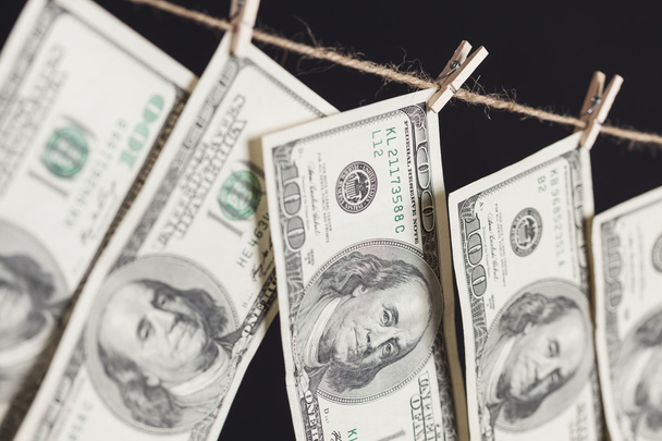 Hundred Dollar Bills Hanging From Clothesline on Dark Background - Fotó, kép