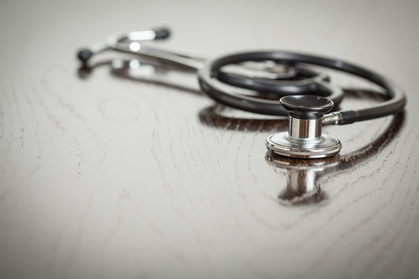 Doctor Stethoscope Laying on a Reflective Table - Photo, Image