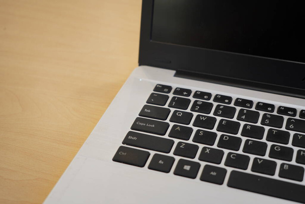 Puolivälissä näkymä kannettava tietokone pöydällä havainnollistamiseksi liiketoiminnan, työ, tai muu online-toimintaa  - Valokuva, kuva