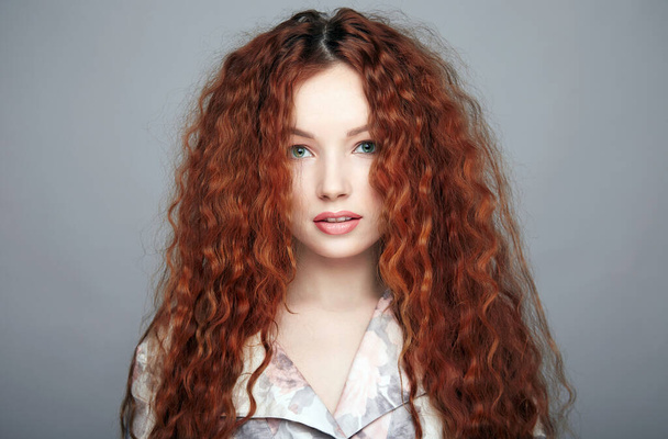 beautiful young woman with curly red hair and make-up. pretty girl in silk pijamas - Foto, Imagem