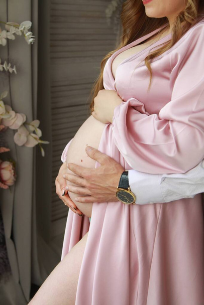 pregnant belly, mom and dad's hands - Fotó, kép