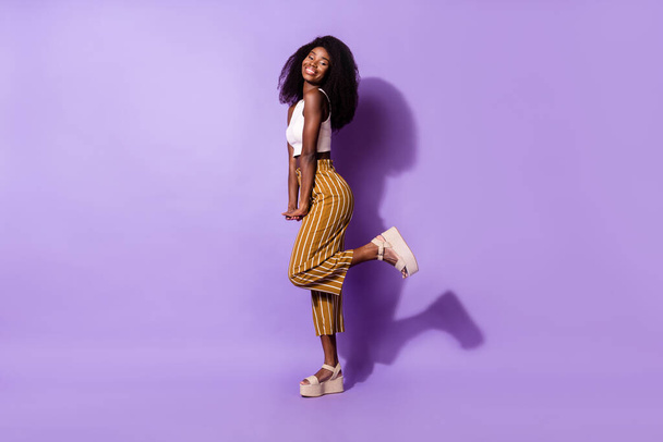 Full length body size profile side view of pretty cheerful girl dancing posing isolated over bright violet purple color background - Fotoğraf, Görsel