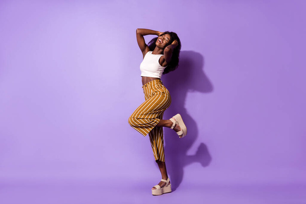 Full length body size profile side view of lovely cheerful girl dancing having fun isolated over bright violet purple color background - Foto, afbeelding