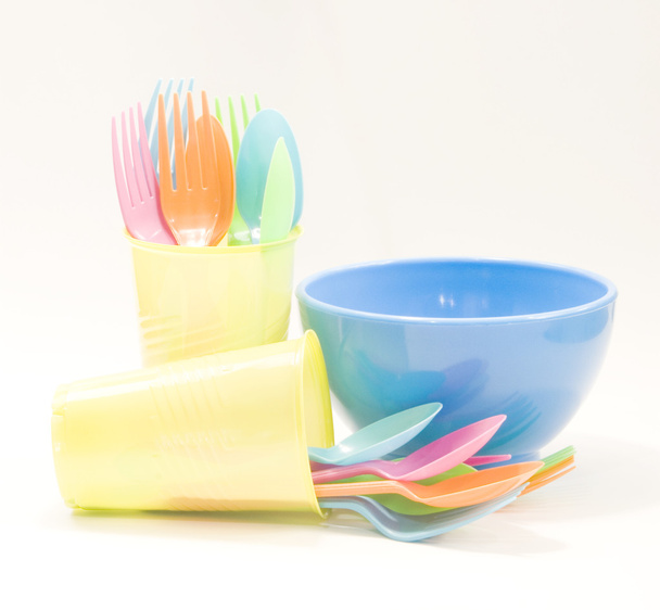 Plastic tableware consisting of spoon, fork, cups and bowls  - Photo, Image