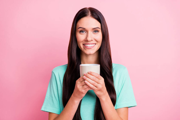 Photo of young beautiful lovely happy smiling positive girl drinking tea coffee isolated on pink color background - Photo, Image