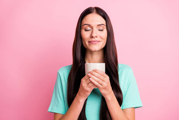 Photo of young beautiful good mood positive dreamy girl enjoying coffee smell isolated on pink color background - Foto, Imagem
