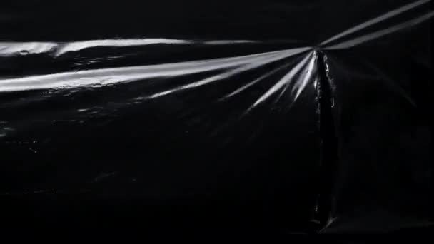 Patroon van cellofaan plastic wrap met vodden gat - Video
