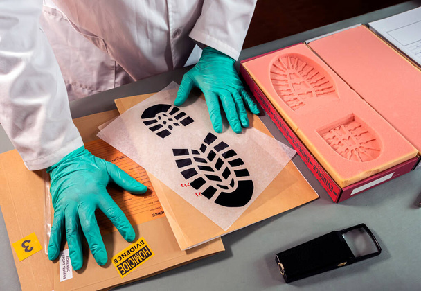 Forensic scientist impatient because he can't find similarity in shoe sole prints in crime lab, concept image - Photo, Image