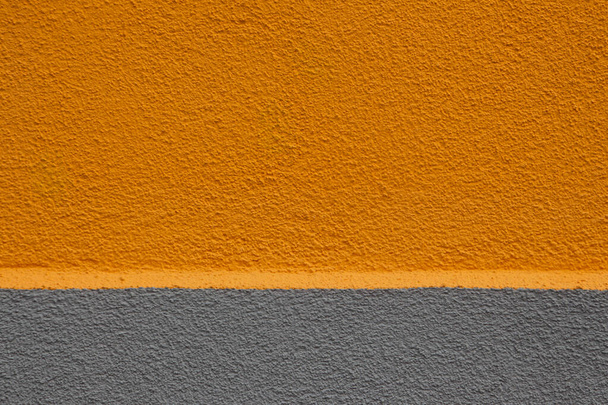 Farbige Wand mit zwei Dritteln oben in orange und einem Drittel unten in grau, getrennt durch einen Sims mit Kopierraum - Foto, Bild