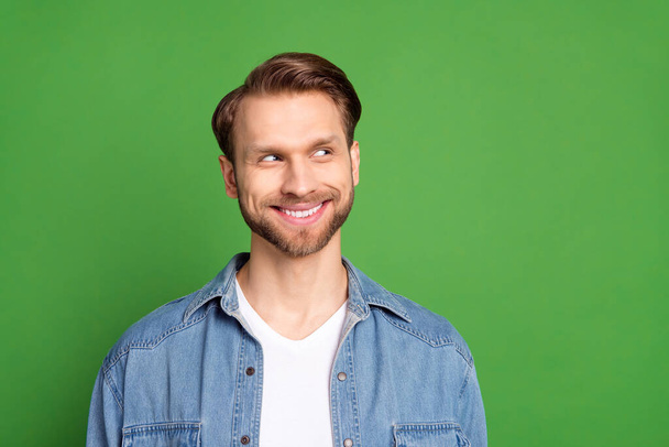 Photo of happy good mood positive smiling handsome man look copyspace dreaming isolated on green color background - Foto, Imagem