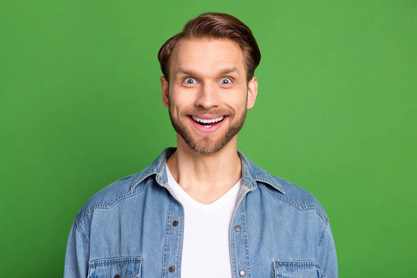Photo of happy smiling excited amazed crazy funky man see huge sale discount isolated on green color background - Foto, afbeelding