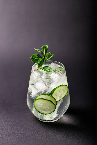 cucumber and mint lemonade in a glass on black table background - Foto, Imagem