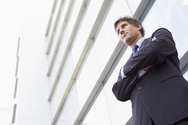 Businessman standing outdoors by building - Photo, Image