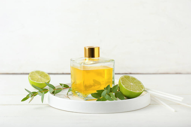 Reed diffuser with lime on light background - Photo, Image