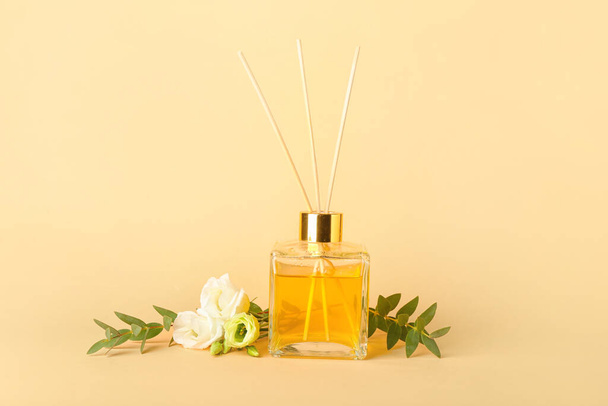 Reed diffuser with eustoma on color background - Photo, Image