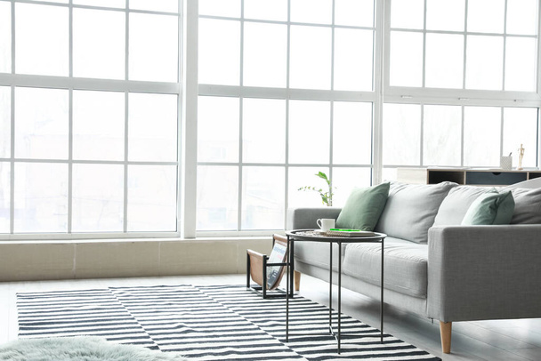 Stylish interior of living room with comfortable sofa - Valokuva, kuva