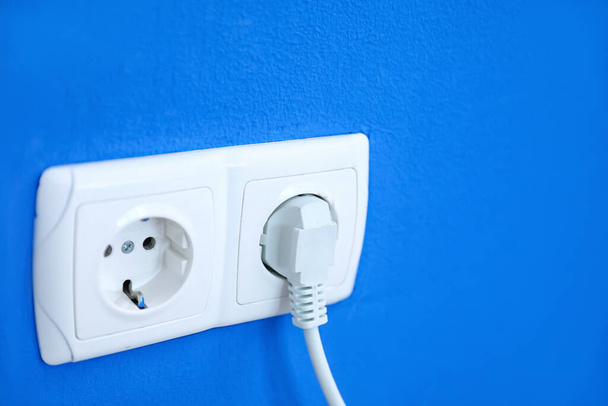 Electric socket with plug on color wall - Photo, Image