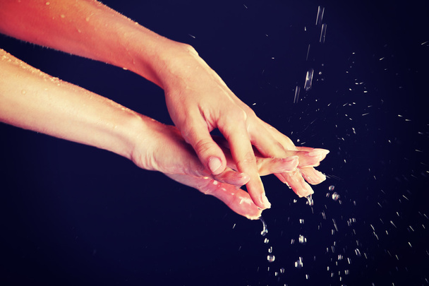 Water falling on female hands - Photo, Image