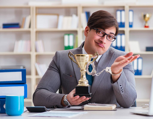 Homme d'affaires avec tasse dorée dans le bureau - Photo, image