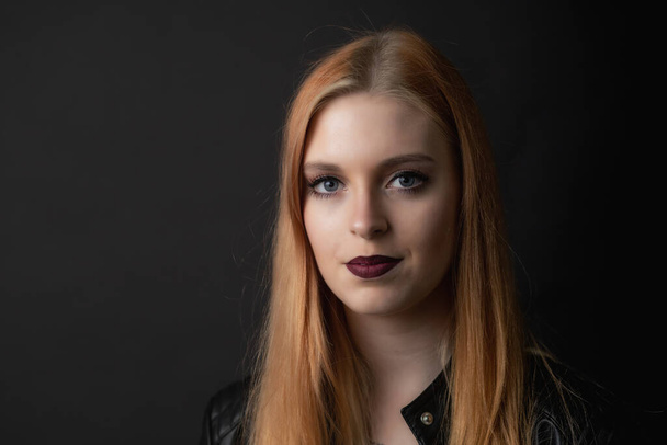 Portrait of beautiful young woman on the black background Horizontally.  - Fotografie, Obrázek