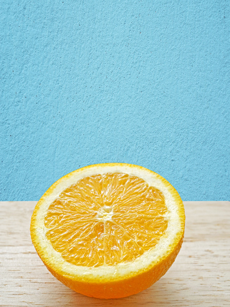Sliced orange fruit with blue wall - Foto, imagen