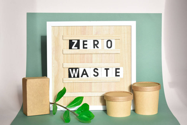 Wooden board with the inscription zero waste with paper packaging - Zdjęcie, obraz