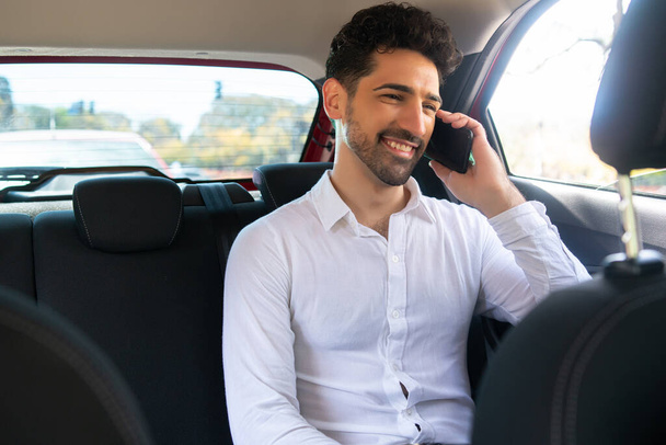 Businessman talking on phone in car. - Фото, зображення
