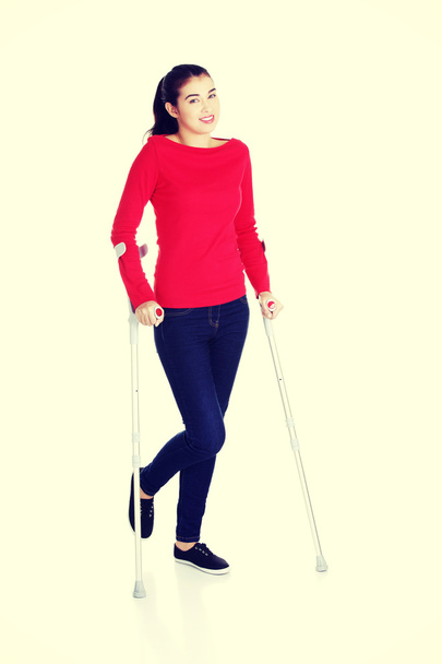 Woman walking with crutches - Foto, Imagen
