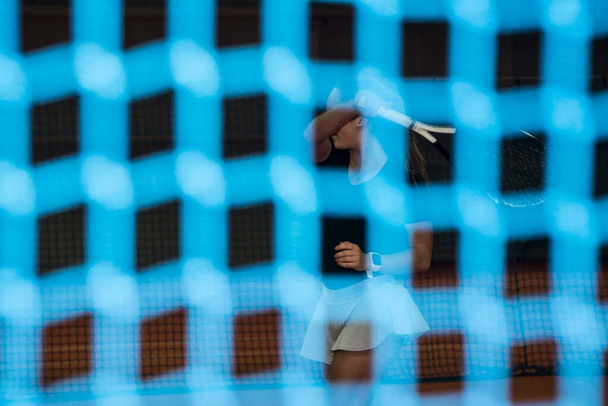 playing a tennis match in a tennis hall, indoor sports - Foto, afbeelding