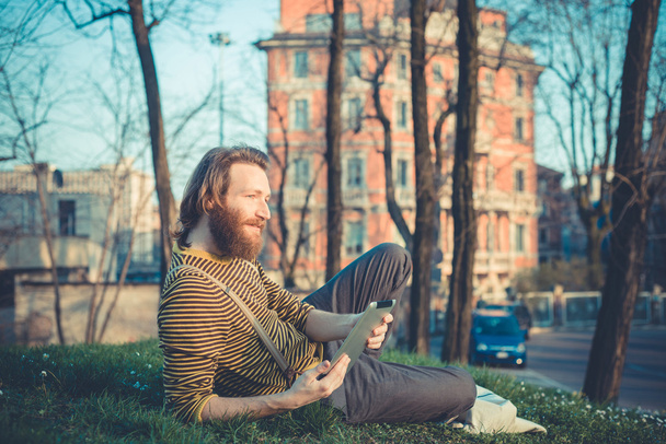 young bearded stylish handsome hipster man using tablet  - Fotografie, Obrázek