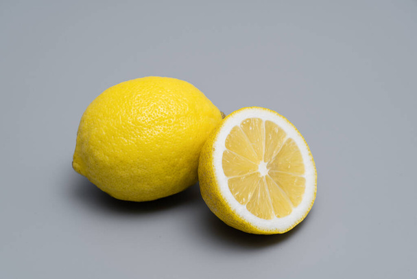 Cut lemon placed on a gray background. - Foto, Imagen