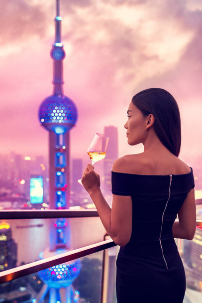 Elegant woman drinking wine - Shanghai rooftop bar - Photo, image