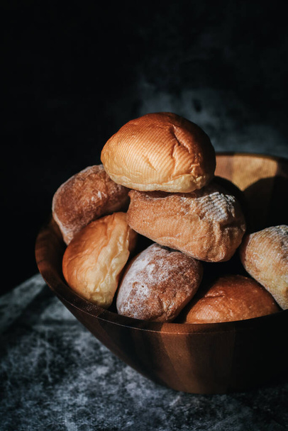 Homemade sourdough and bread bun. Freshly baked bread. Organic whole-wheat loaves. Simple breakfast on grey concrete background.  - Foto, Imagen