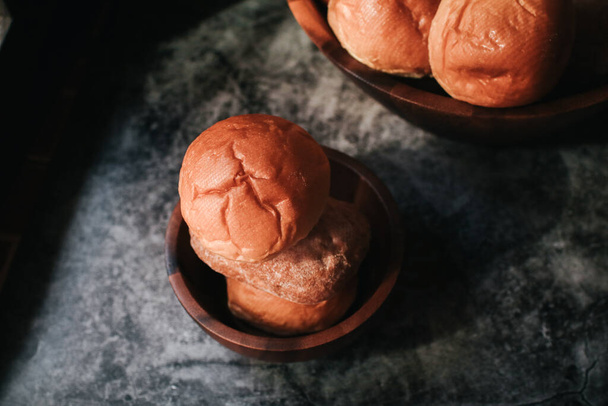 Homemade sourdough and bread bun. Freshly baked bread. Organic whole-wheat loaves. Simple breakfast on grey concrete background.  - Foto, Imagen