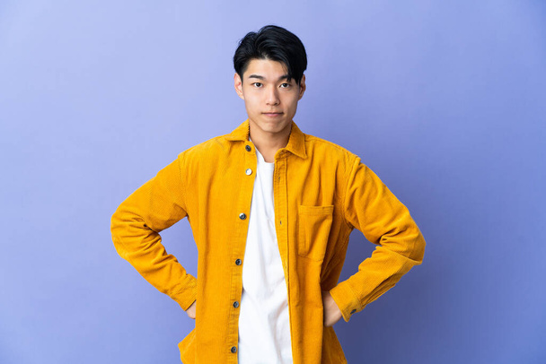 Young Chinese man isolated on purple background angry - Photo, Image